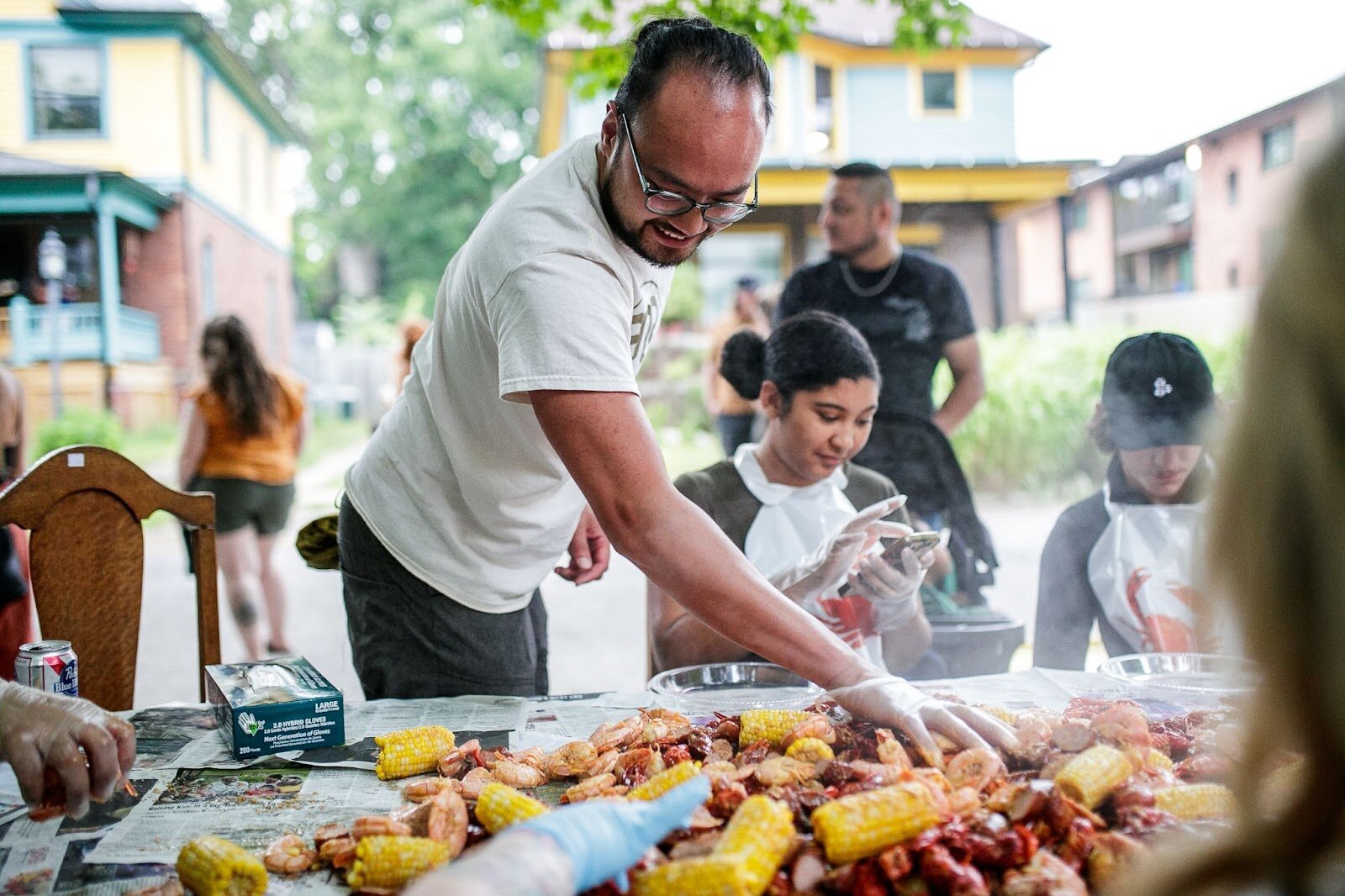 Tony Vu spreads his seafood boil dinner out for special guests during Porch Fest on Friday, July 15, 2022. (Jenifer Veloso | Flintside)