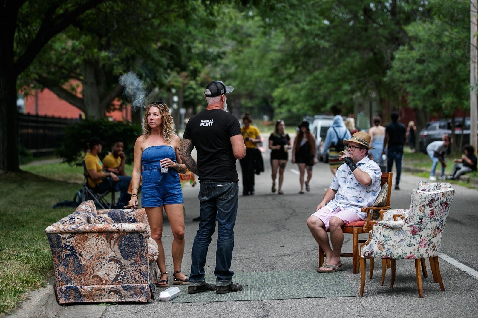 Guests enjoy outdoor seating, drinks, and cigars during Porch Fest on Friday, July 15, 2022. (Jenifer Veloso | Flintside)