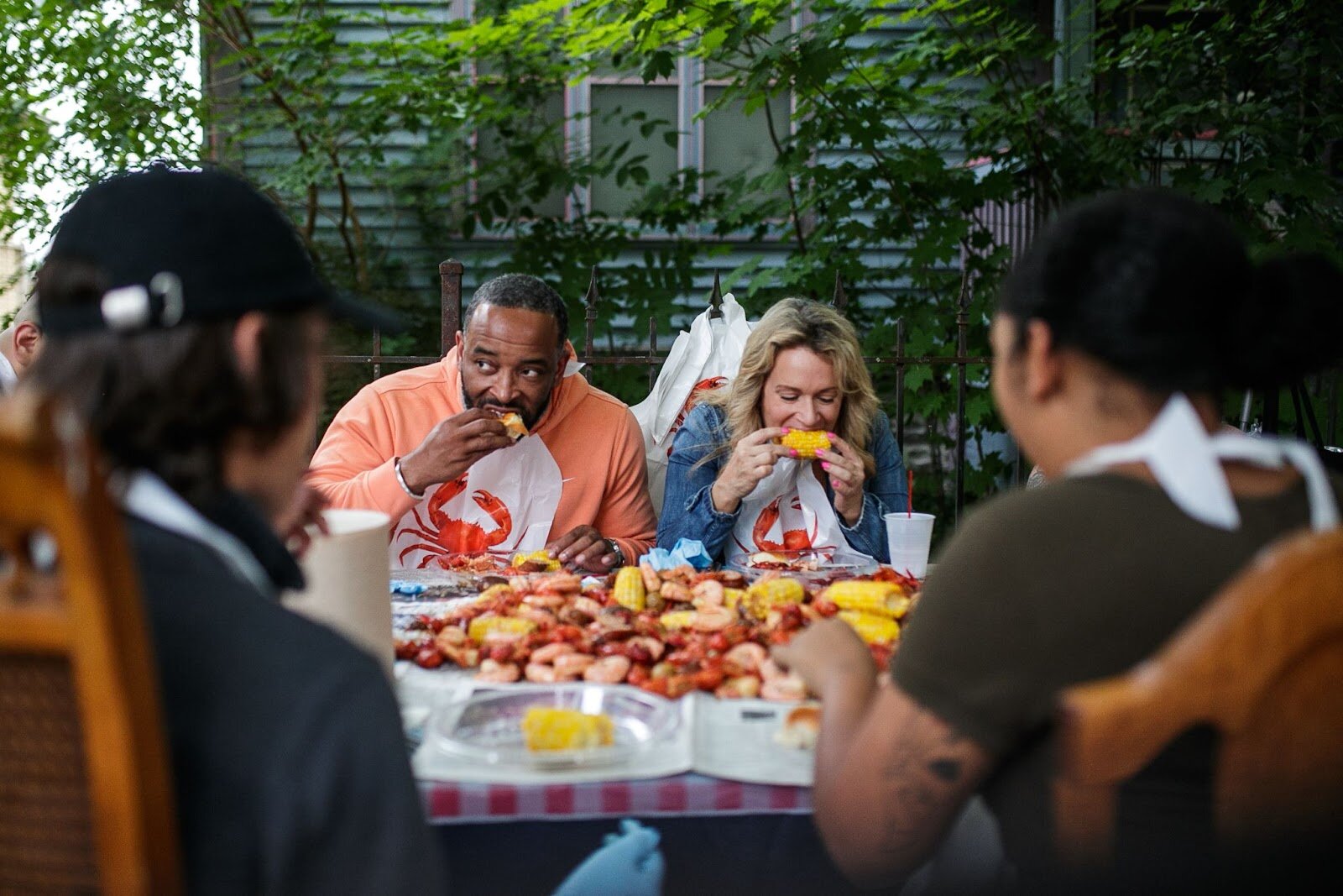 Guests dive into the fresh seafood boil during Porch Fest on Friday, July 15, 2022. (Jenifer Veloso | Flintside)