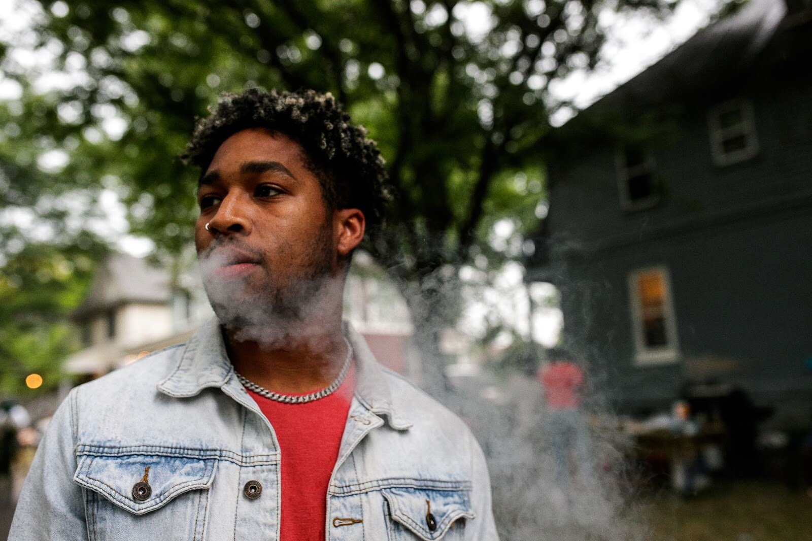 Torandis Mack smokes as he enjoys a moment during Porch Fest on Friday, July 15, 2022. (Jenifer Veloso | Flintside)