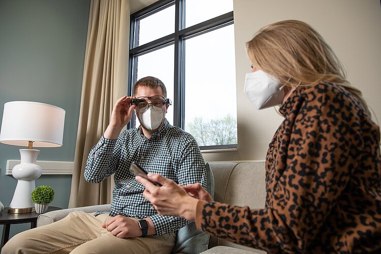 Dayna Roe, Samaritas director of memory care, demonstrates smart glasses with a colleague.