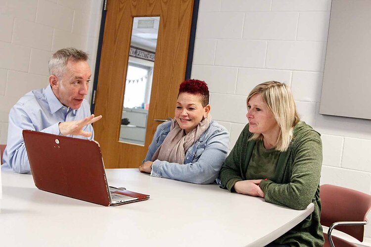 Ethan Alexander, Behavior Specialist Mary Carter, and Principal Lindsey Newton confer at Kalamazoo's Northwood Elementary.