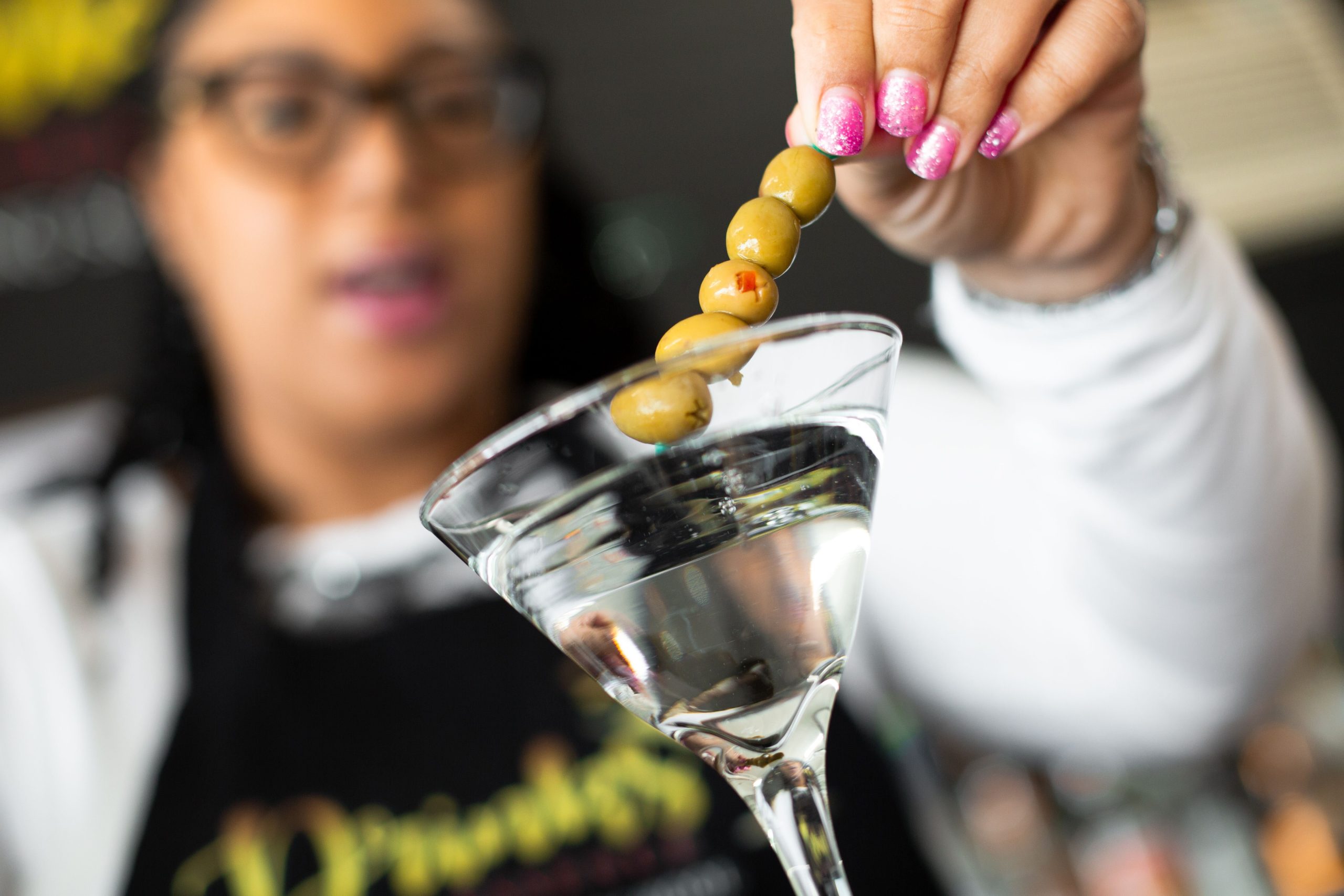 Harrison puts the finishing touch on a classic dirty martini.