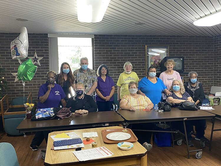Residents of Burton Senior Center in Burton celebrate completing their Fresh Conversations program with Nutrition Educator Amanda Mattila.