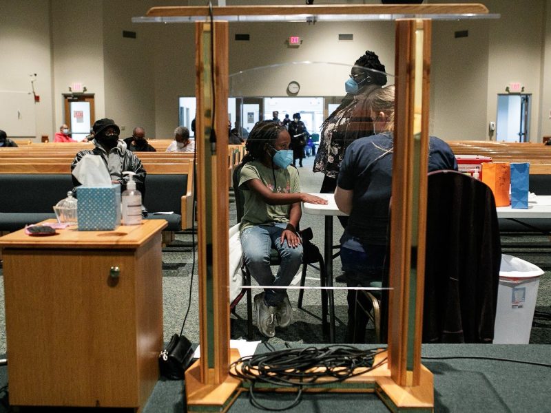 India Aikins, age 9, receives her first dose of the Pfizer vaccine at the Genesee County Health Department pop-up clinic hosted at Shiloh Missionary Baptist Church.