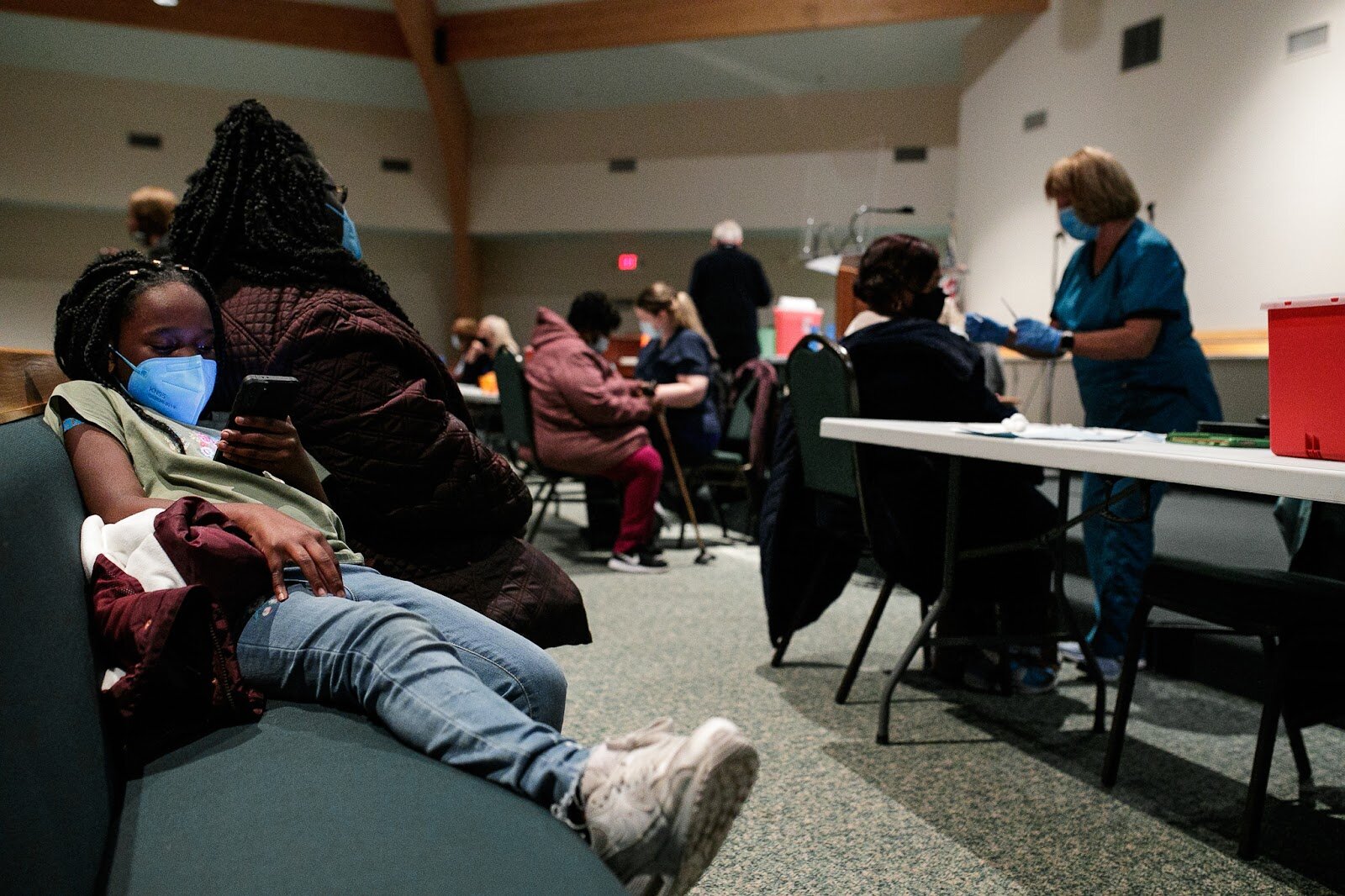 India Aikins waits with her mother Tonyetta Aikins after receiving her first dose of the Pfizer vaccine.