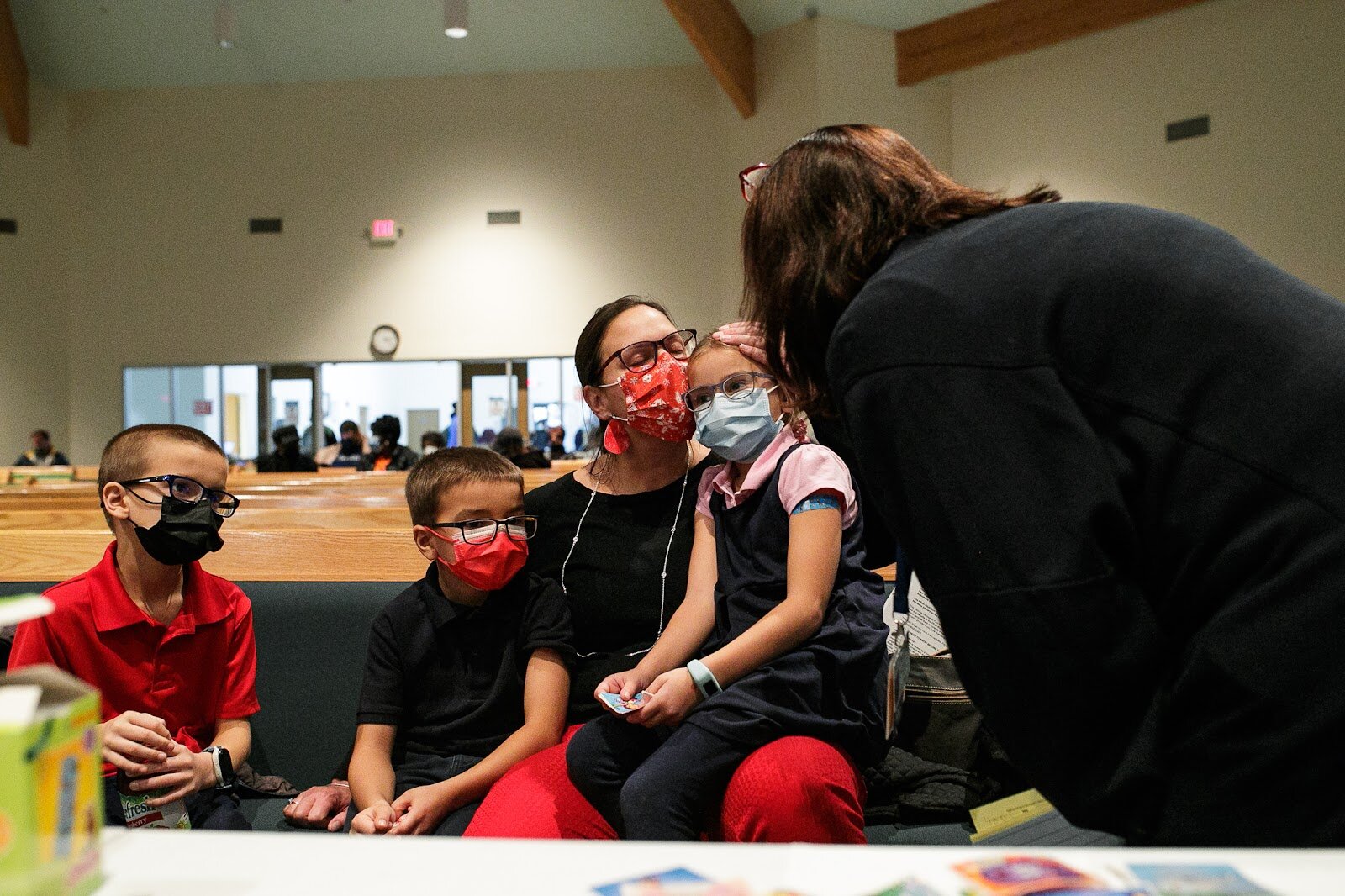 Courtney Childers, the mother of Dylan (age 9), Preston (age 8), and Charlotte (age 7) holds her children while GCHD registered nurse Joanne Herman provides COVID-19 information.