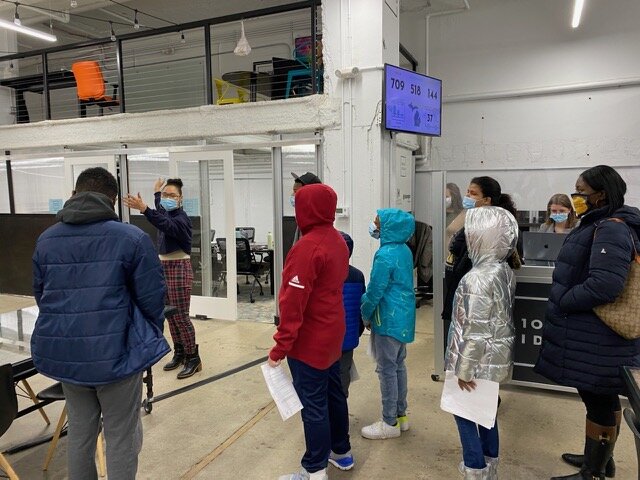 Participants in the GEARup2GROW program take a tour of 100K Ideas inside of Ferris Wheel in downtown Flint.