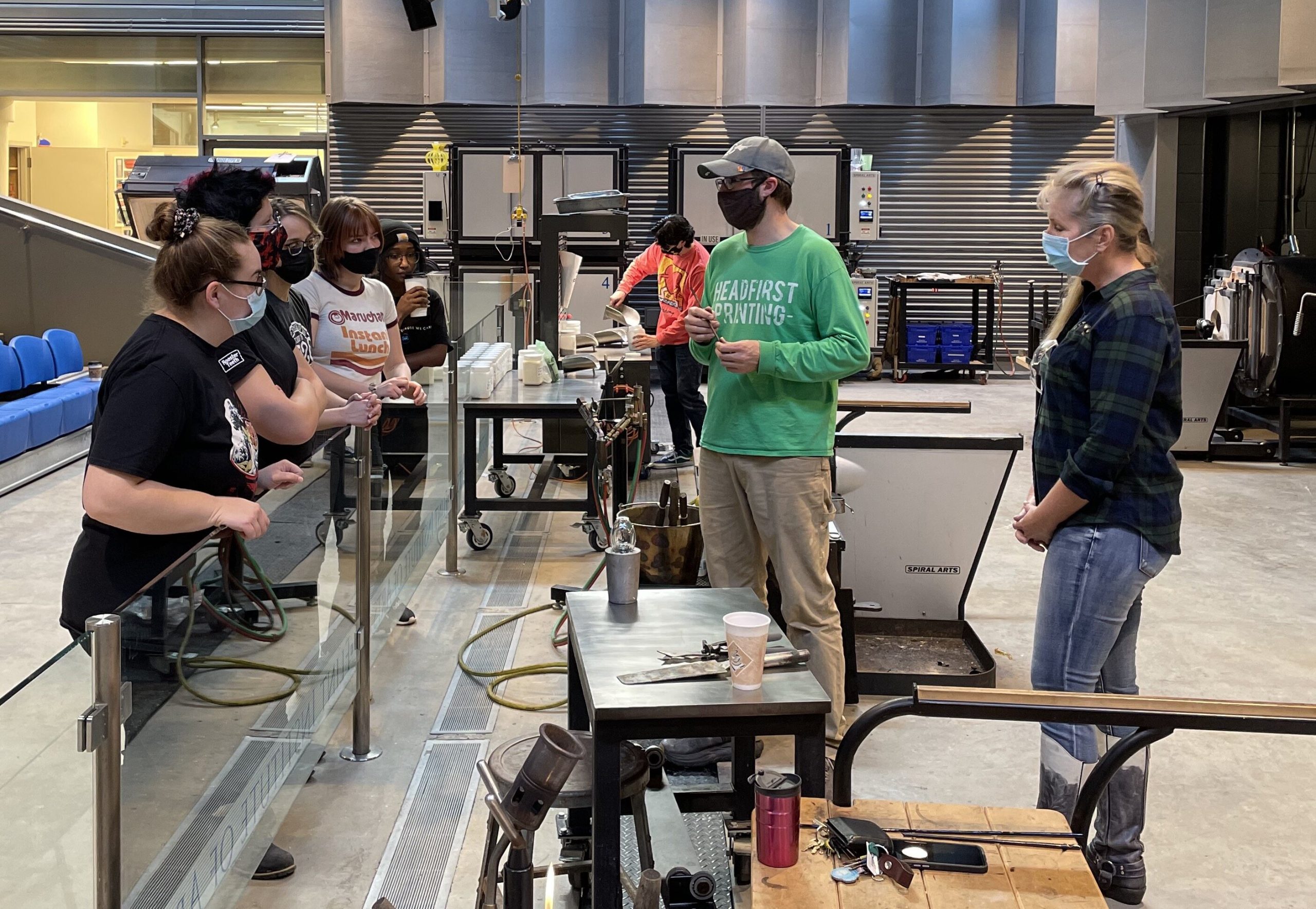 Brent Swanson, FIA glass programs manager, and Cristen Velliky, Associate Professor of Art at UM-Flint, discuss glassworking techniques with UM-Flint students in the FIA’s Glass Blowing studio. 
