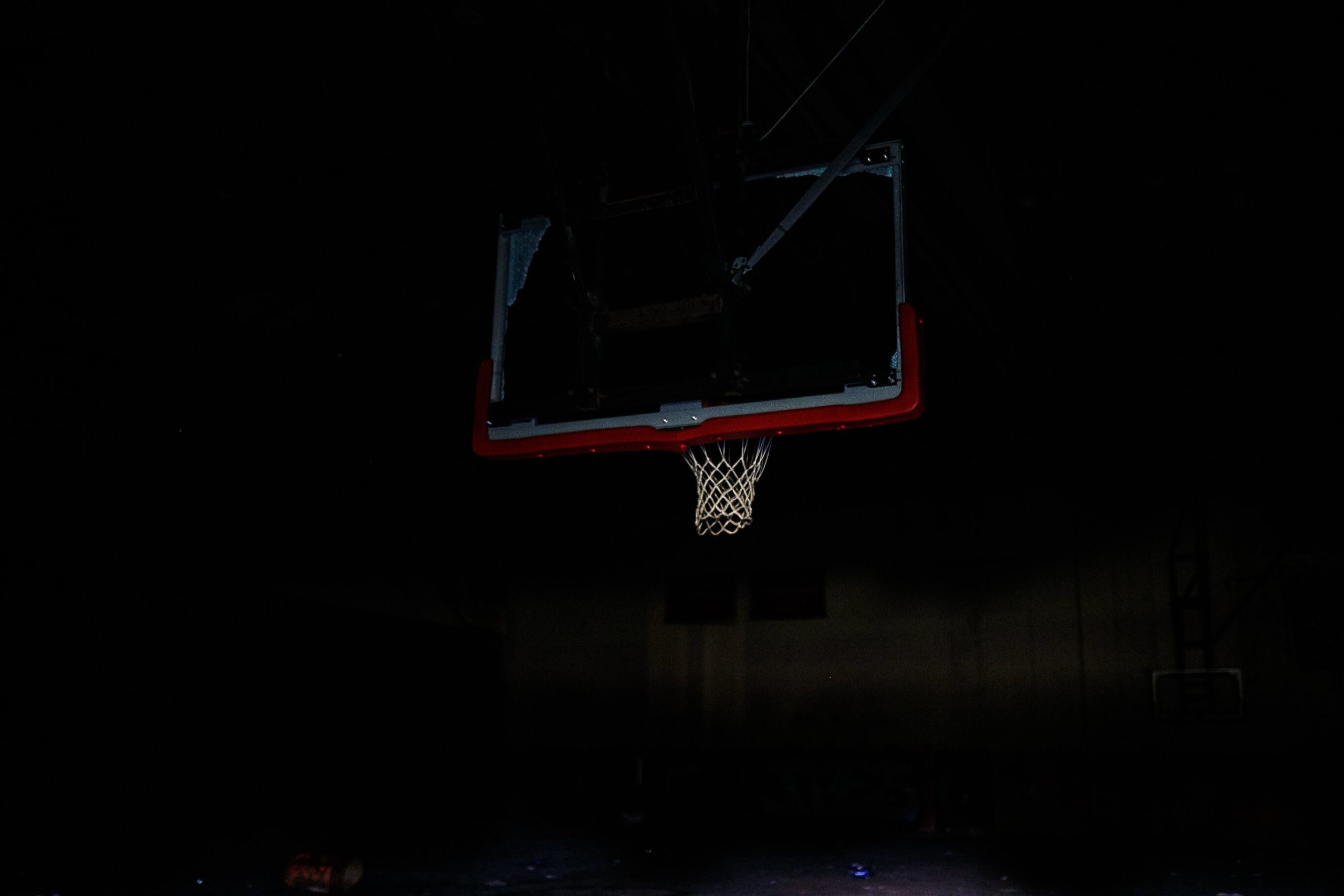 A destroyed basketball backboard remains hanging inside the gymnasium of Flint Central High School. In June 2009, Flint Central High School held its last day of school. It remains abandoned and structurally unsafe.