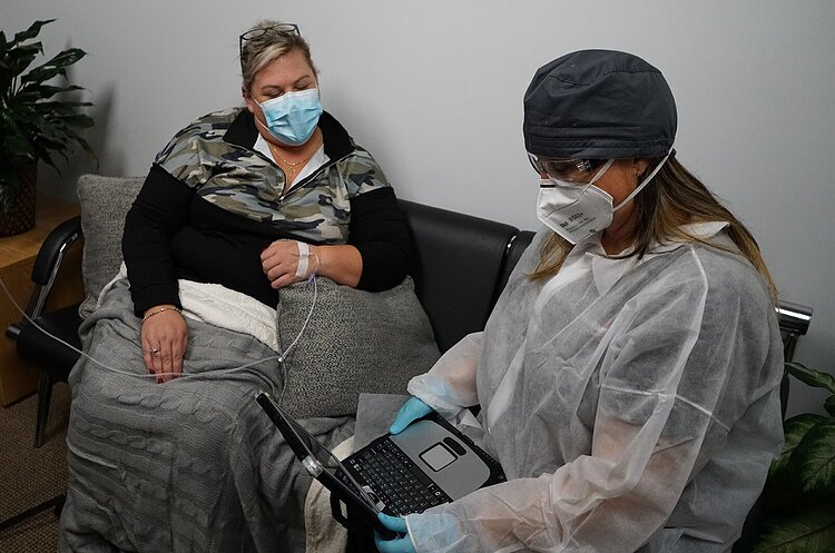 Medstar Mobile Health Paramedic Nicole Plauman demonstrates an in-home monoclonal antibody IV therapy setup.