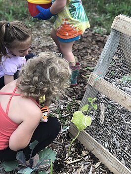 Children in the Child and Family Charities Family Growth Center's community garden.