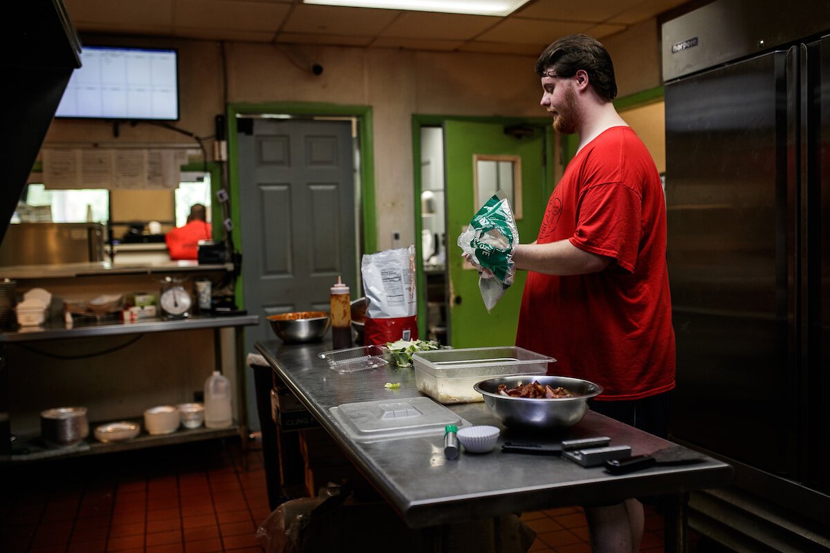 Corey Eikamp, friend and family to co-owner's Ron and Alissa Housley, runs the grill at Maude's Alabama BBQ.