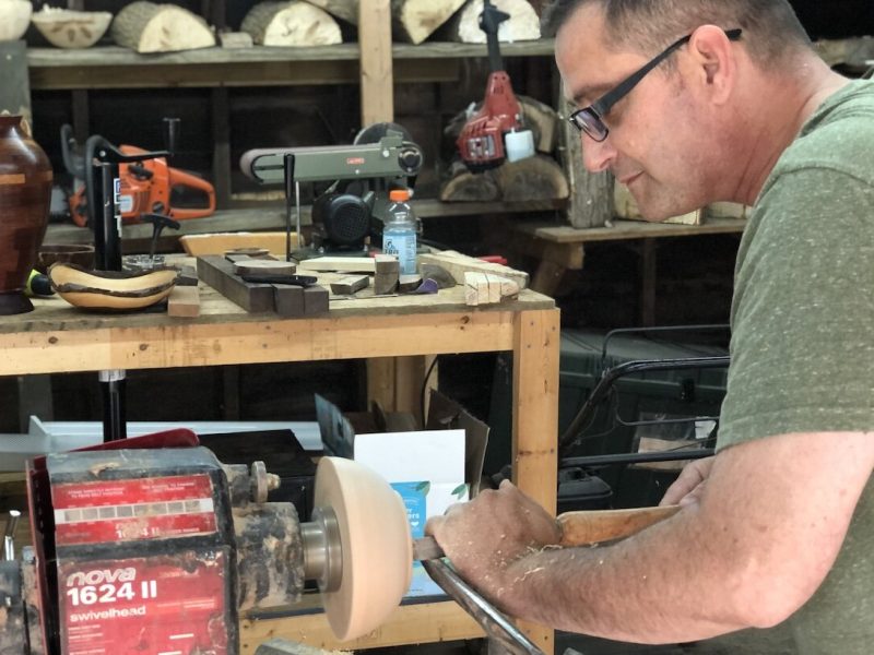Russ Dotson creating a wood bowl on his lathe in his College Cultural Neighborhood garage.
