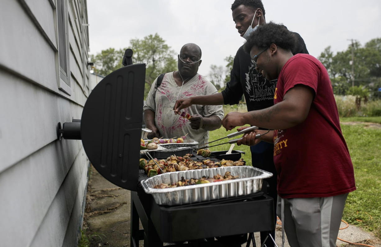 Kevin Croom works with Asbury Church's youth-led program, Sizzling Culture, and shows students how to assemble and cook shish kabobs during the Eastside Franklin Park yearly craft fair in July.