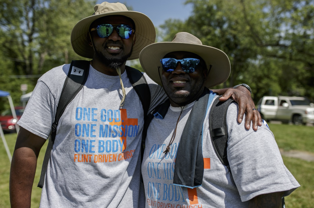 Pastor Dion Lewellen and associate pastor Derrick Hullum from Flint Driven church, both pose for a photo during a barbecue on June 5.