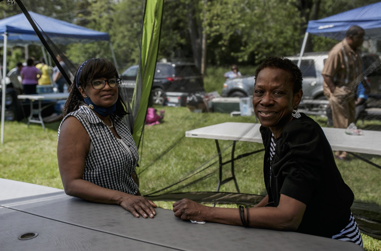 Yvonne Davis and Aniska Craig, Flint residents, talk during a barbecue at Amos Park on June 5.