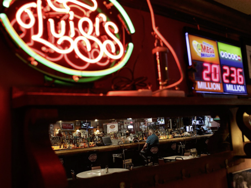 A customer waits at the bar inside Luigi's restaurant.