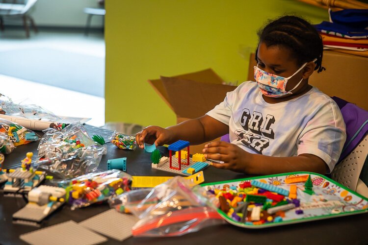 A Girl Scout pieces together her project during a Robotics workshop offered through the Girl Empowerment Program.
Photo by David Lewinsky