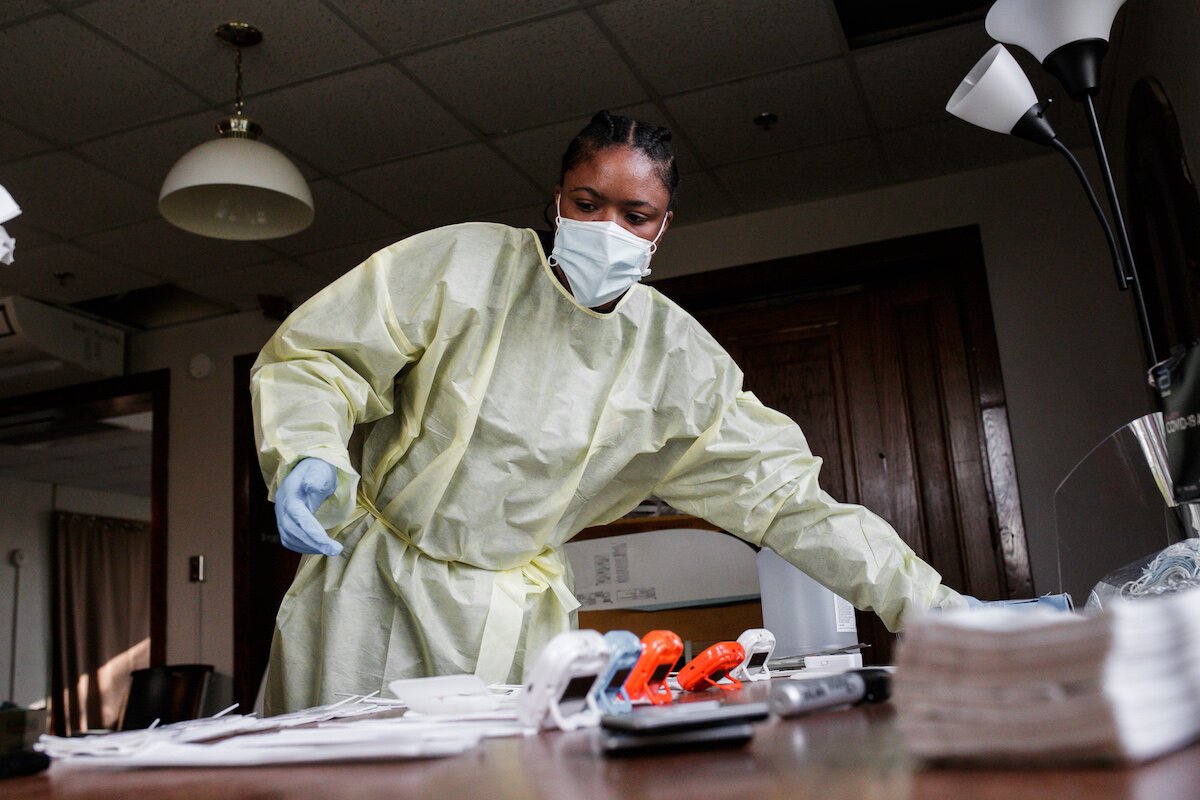 Faye Rankin, a Honu Lab employee, helps set up testing for residents and employees at Shelter of Flint.