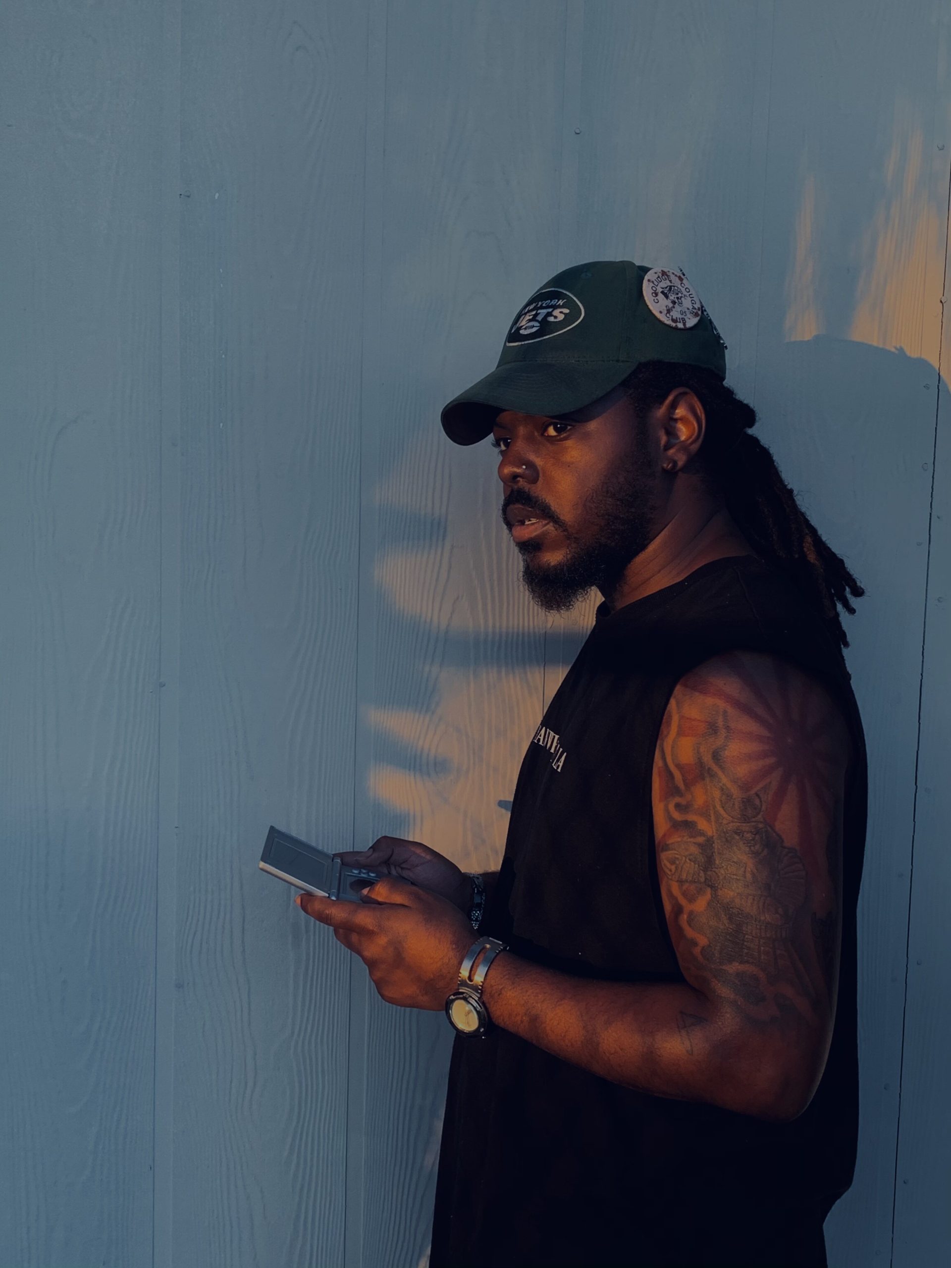 24-year-old Flint native and Arizona born Matthew Wiley, sitting, reflecting, and playing his Nintendo DS.