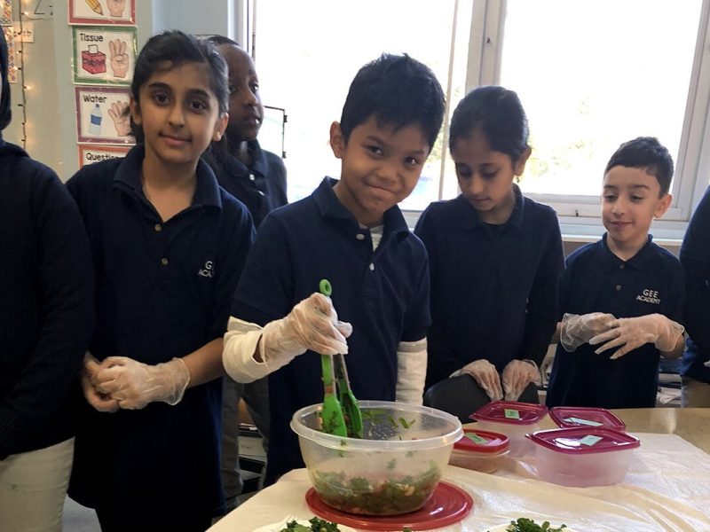 Students toss a healthy kale salad.