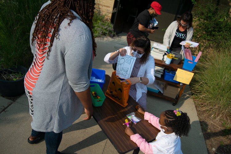 Maher and Sherrita Felton go over study materials Janae has to work on at home. 