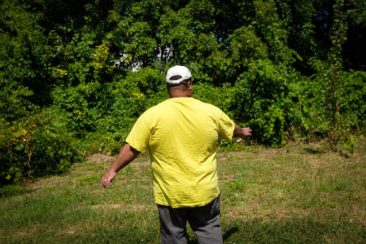 Alan Jennings has an encyclopedic knowledge of plants, which manifested in a garden he grew a couple years before his mother's death in 2016. He motions towards the backyard expanse where his garden used to be.