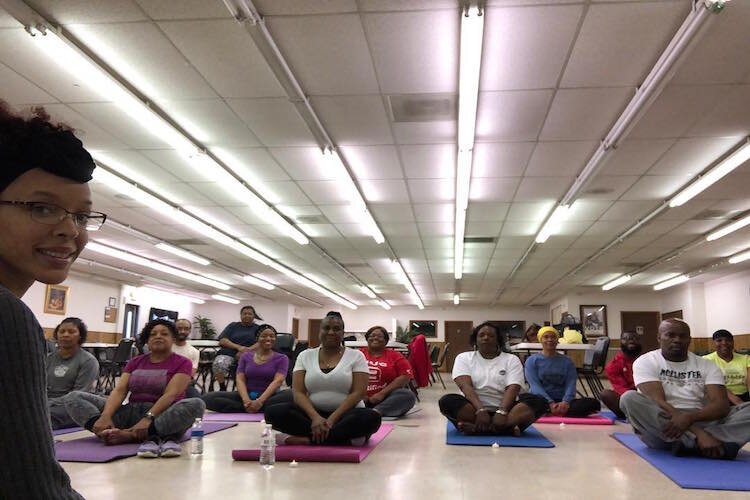 Canisha Bell leads a meditation at Ebenezer Ministries in April 2019. 