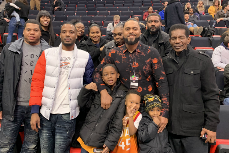 Family and friends of Eric Woodyard, who covers the Utah Jazz for the Deseret News, pose for a photo with Woodyard after a Detroit Pistons game at Little Caesars Arena.