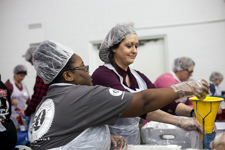 Maegan Weller, right, of the Valley Area Agency on Aging works with Americorp member Amanda Collins, who says, “It makes you feel good to help actually do something that will have a positive impact on the lives of people who go hungry.” 