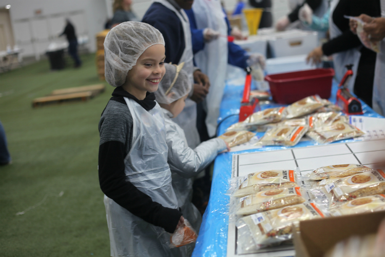 Natalie Chapa looks over the finished food boxes she assembled along with her mother, Crystal Chapa, and sister, Addison, 5. 