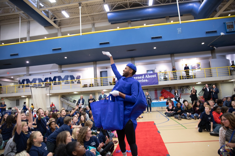 Isaiah Oliver, president of the Community Foundation of Greater Flint, made a surprise visit in Phil Shaltz's blueberry costume.