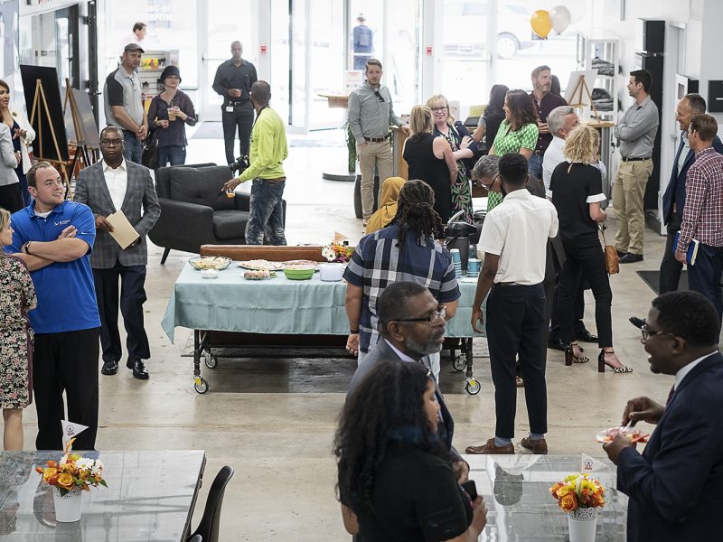 Flint, MI - Thursday, June 22, 2018: Attendees gather in the lobby at The Ferris Wheel in Downtown Flint for the move-in party.