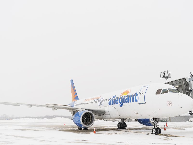 An airplane, part of the Allegiant fleet, waits on the tarmac to be boarded and loaded with luggage at Bishop International Airport.