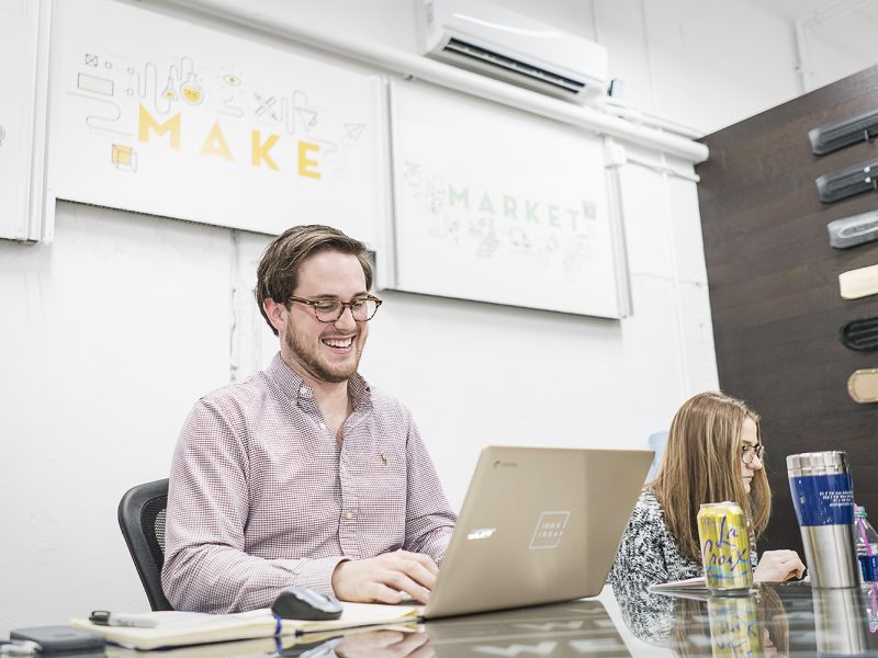 Gabriel Stone, 22, of Lapeer, (left) works on a project binder for a client at 100k Ideas. As a project manager, Stone assists inventors and innovators through the process of making their ideas a reality.