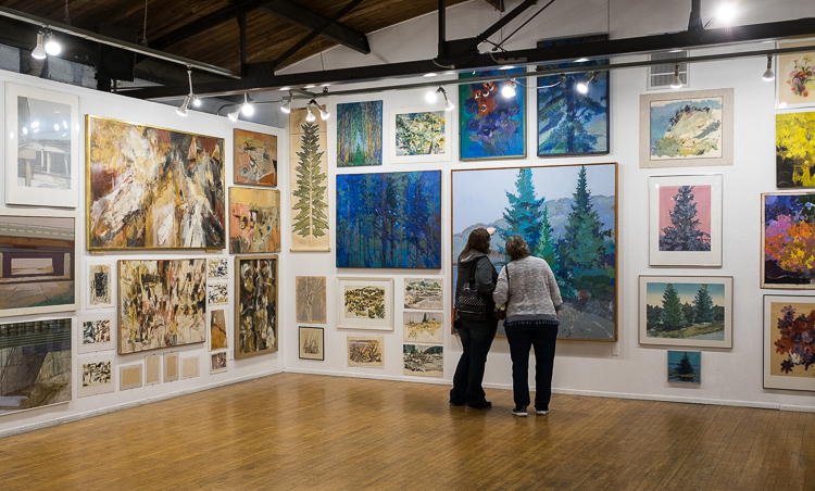 Patrons experience the Stefan Davidek exhibit at Buckham Gallery in Flint.