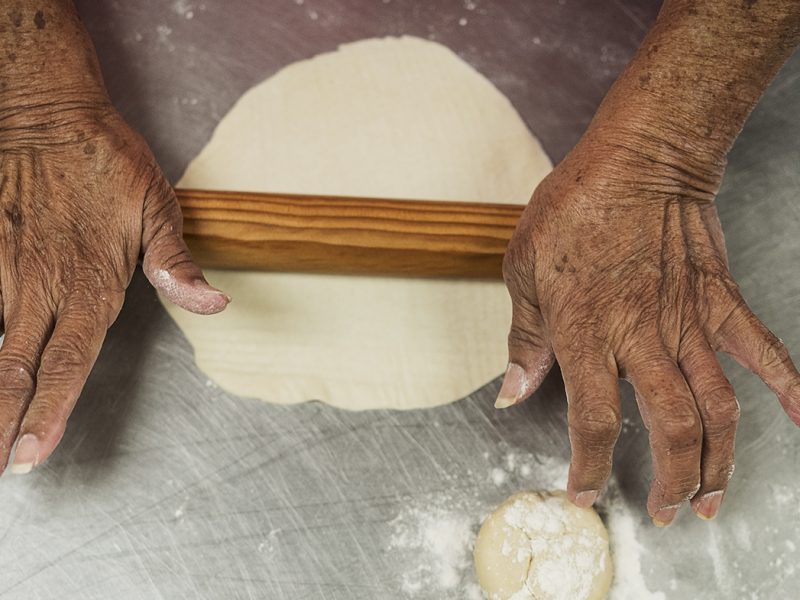 Ofelia Luna, 79, of Flint, rolls out masa to make tortillas, a weekly tradition at Our Lady of Guadalupe Catholic Church.