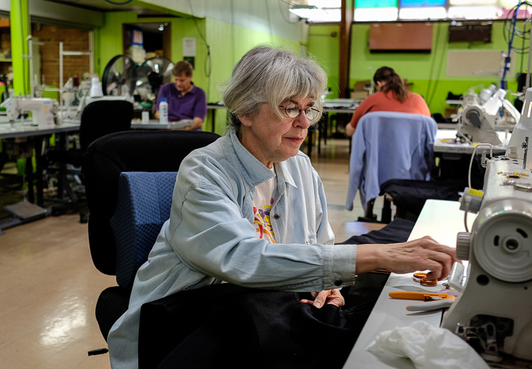 Employee Marty Calhoun of Flint Township assembles a vest that is part of a contract with Stormy Kromer, the nationally known outdoor wear manufacturer located in Ironwood. Calhoun also teaches sewing. The vests are individually handcrafted on indust