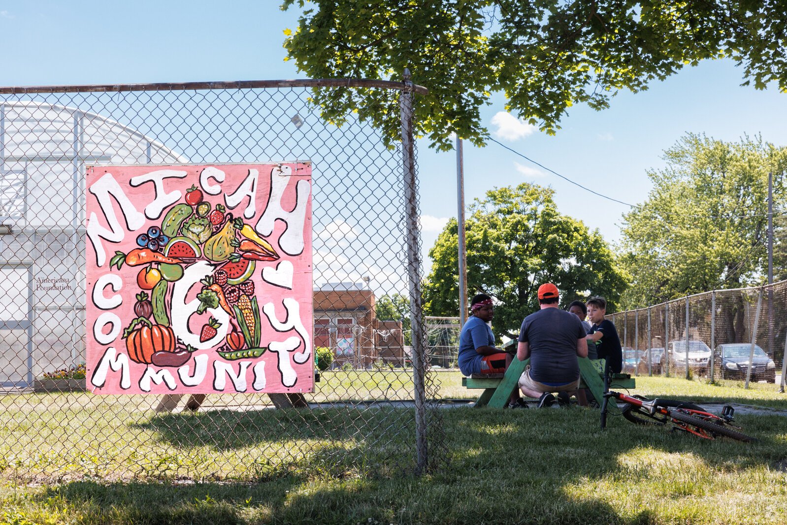 Micha 6 executive director Coleman Yoakum meets with community kids at the Micah 6 hoop house near the new community center that is under renovation.