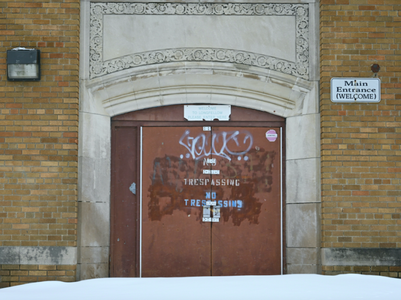 The main entrance of Longfellow Middle School in Flint, Michigan displays "no trespassing" warnings and graffiti on March 13, 2023. The school closed its doors in 2007.