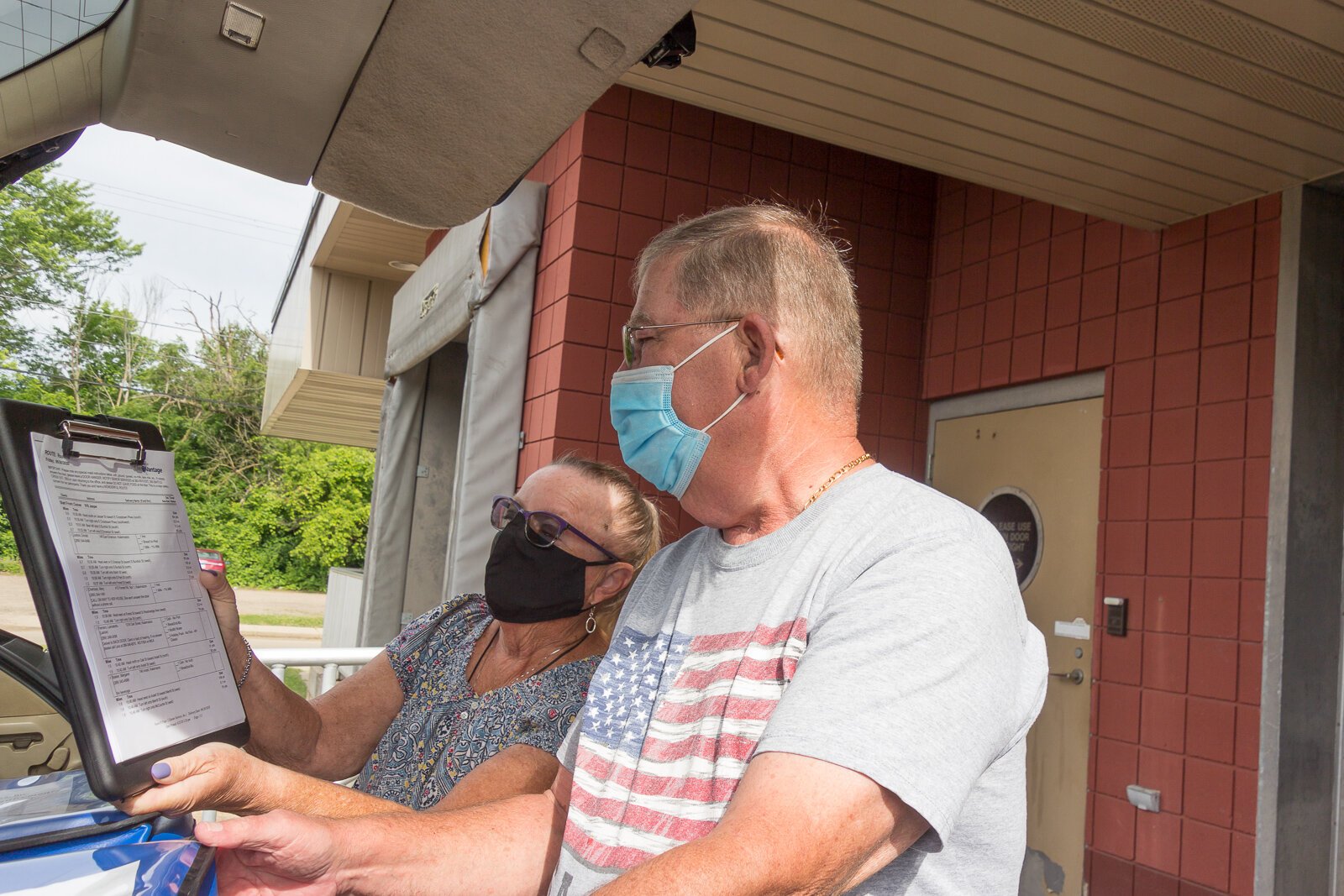 Marcia Hutchins and Jim Geerligs check a delivery list for Senior Services Southwest Michigan.