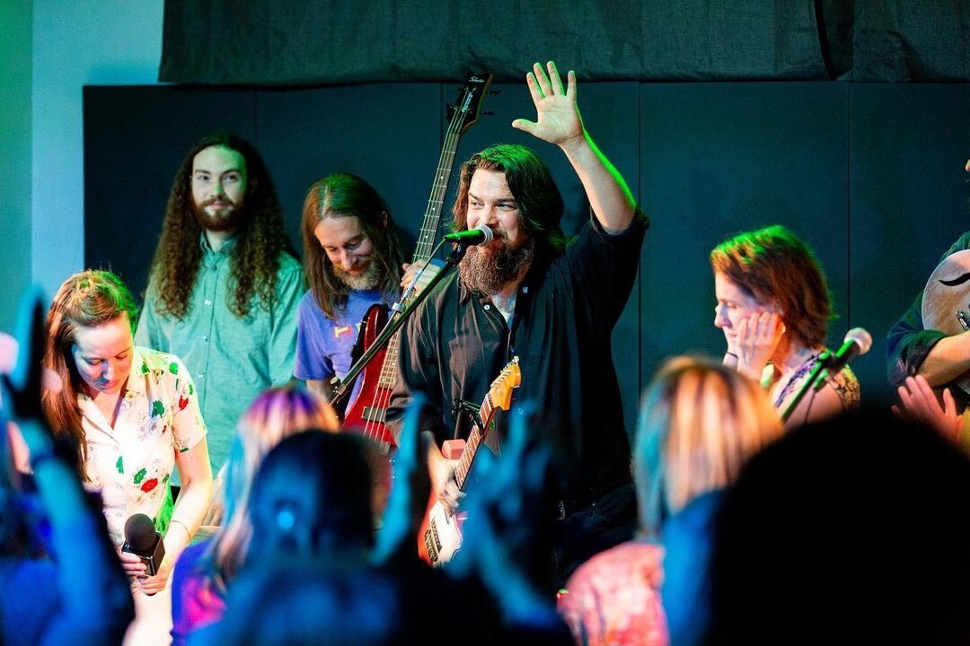 Seth Bernard, Michigan musician and founder of Earthwork Music, waves to the crowd during a performance. (Photo credit: Shawn Roach)