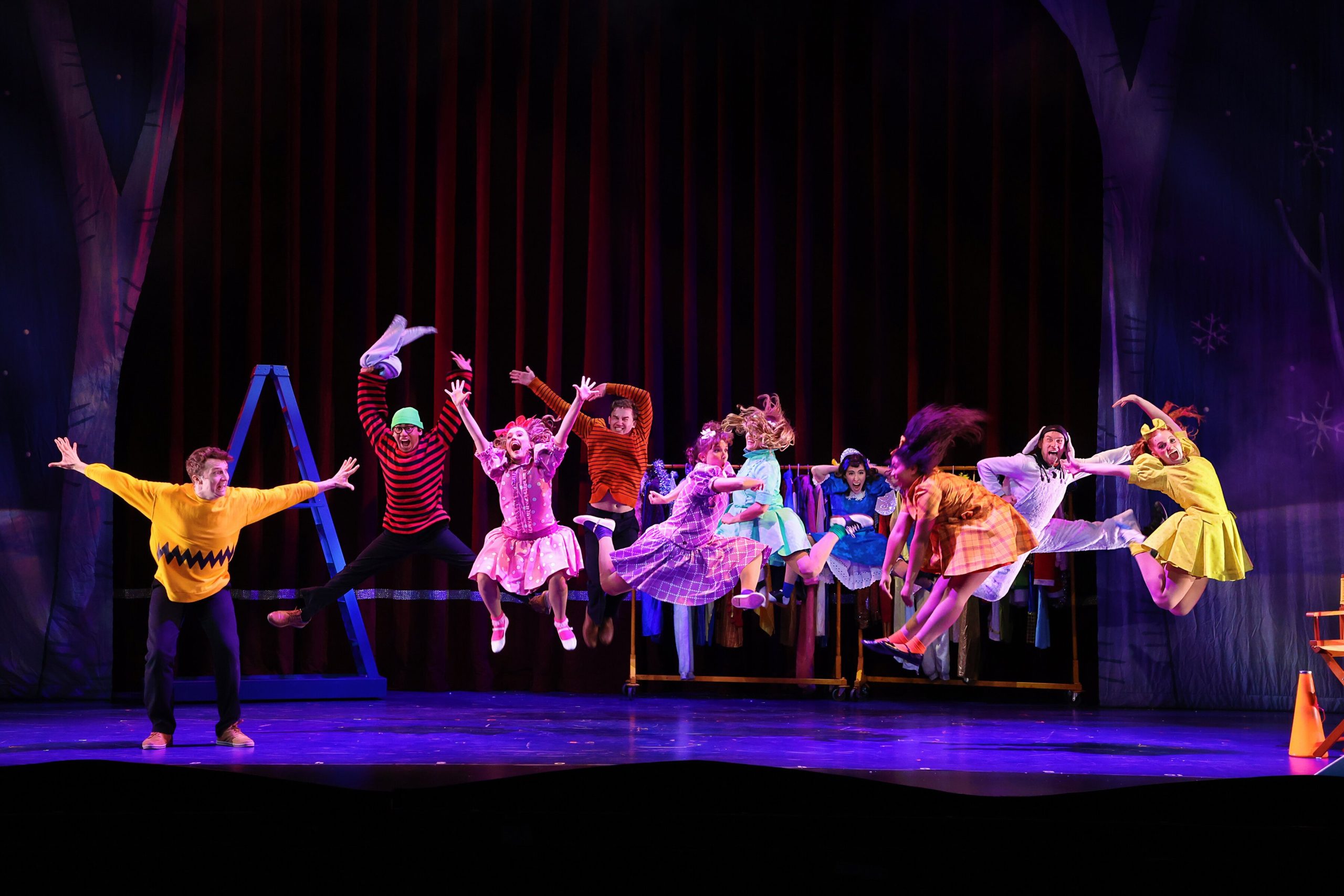 The cast of ‘A Charlie Brown Christmas’ leap for holiday joy on stage at the FIM Whiting Auditorium.