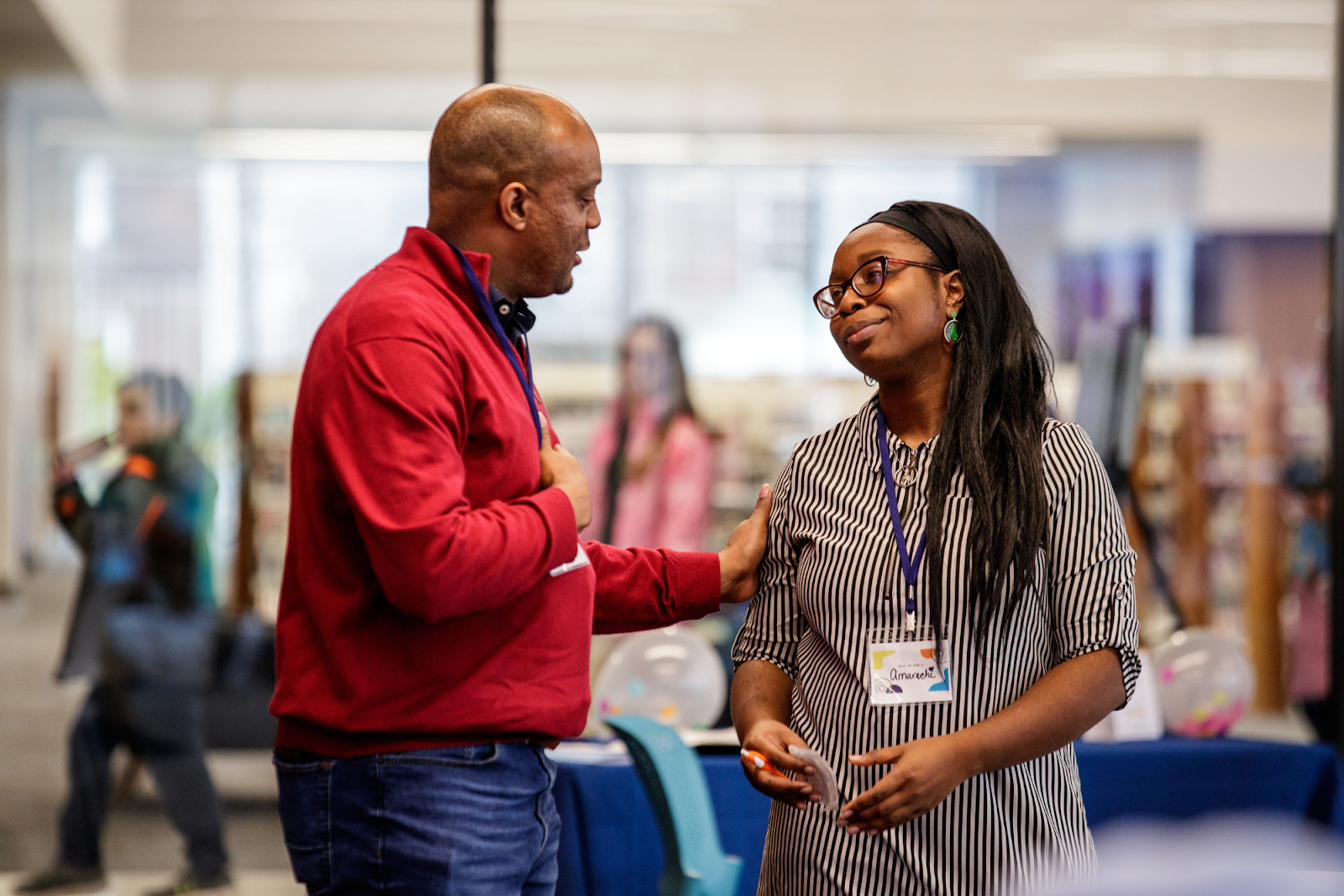 Event organizers and facilitators Doron Pratt and Amarachi Wachuku share a tender moment during the Stories of Survivors event on Dec. 8, 2023. (Jenifer Veloso | Flintside.com)