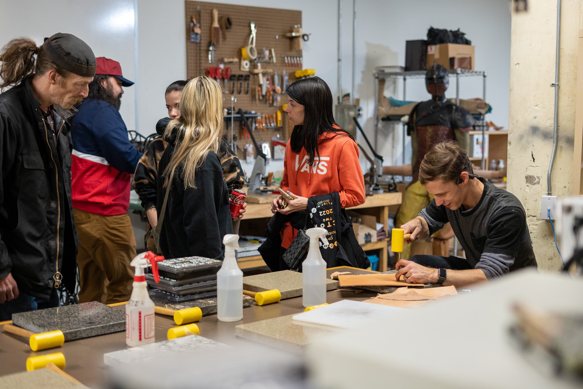 Participants at a previous Factory Two event experience a live leatherwork demonstration.