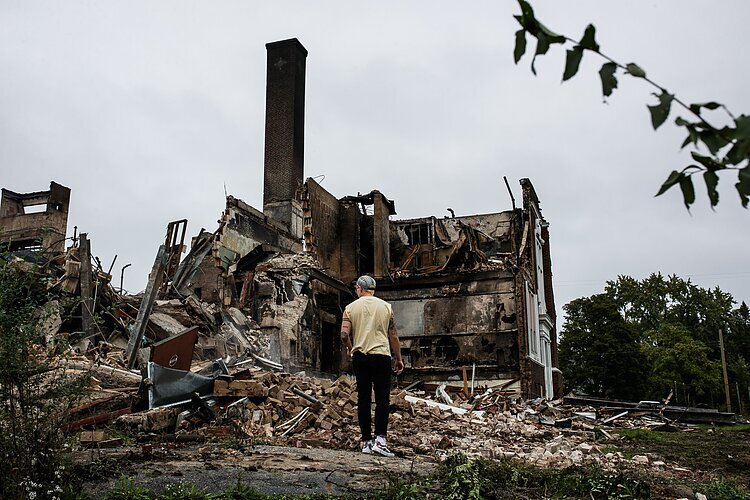 An onlooker views the damage of Flint's Washington Elementary School after it was set afire in October 2021.