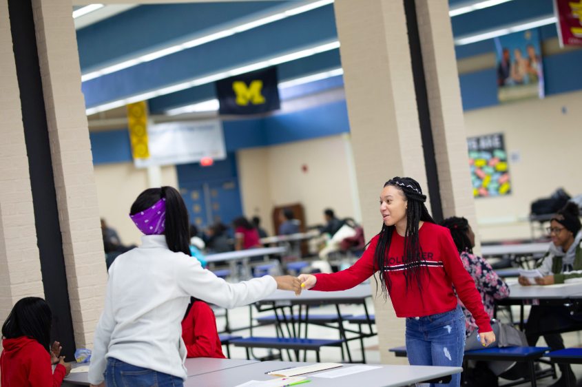 Two students practice handshaking during TeenQuest's job preparedness program.