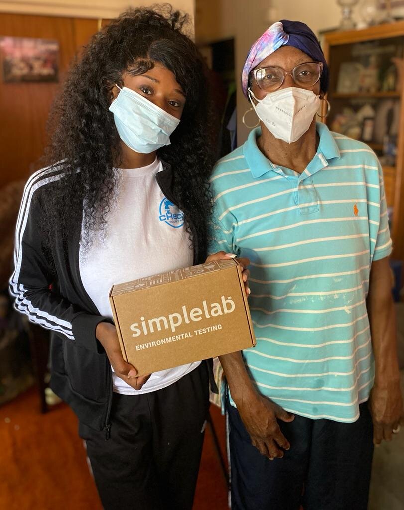 A youth volunteer for the NCWC poses for a portrait holding a Simplelab environmental testing kit. Courtesy photo provided by Syrah Scott.