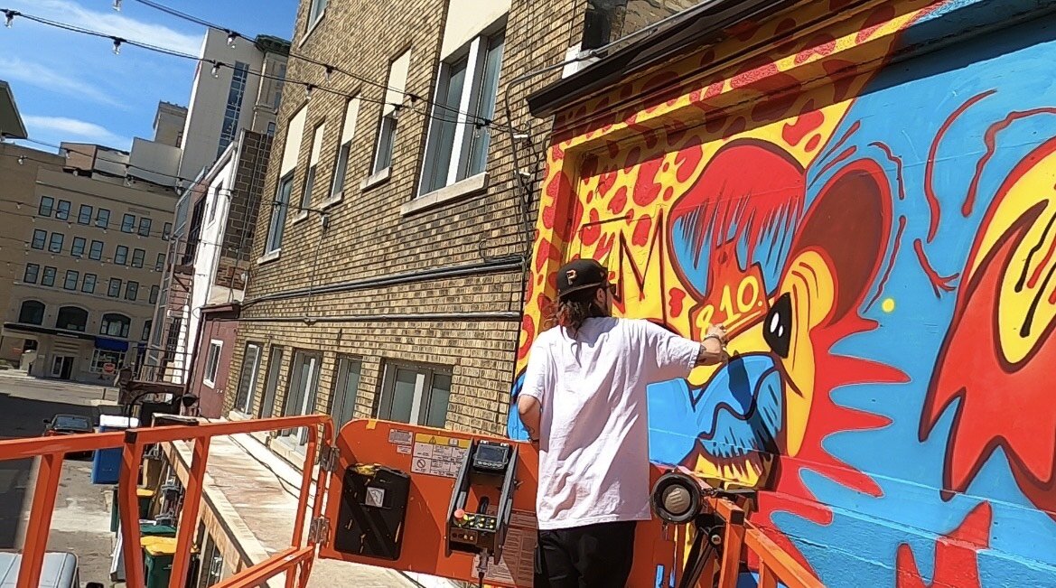 Everett working on a mural in downtown Flint.